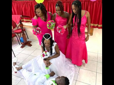Bridesmaids (from left) Octavia Headley, Shamair James (maid of honour) and Jaina Henry, look on as their friends Anishka and Davion ‘Nah Bade’ Hodges have a little fun inside the Calvary United Worship Centre.
