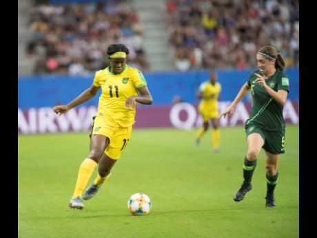 Khadija Shaw (left) dribbles past Australia’s defender Karly Roestbakken in  the  FIFA Women’s World Cup at the Stade des Alpes in Grenoble, France, last June.