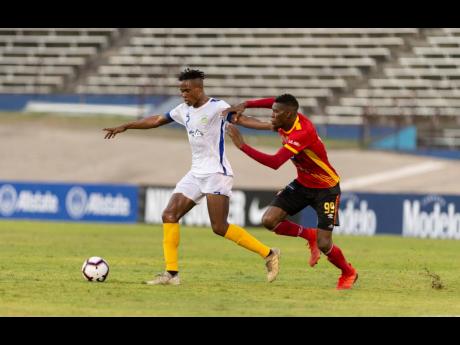 Waterhouse’s Stephen Williams (left) is challenged by Keyner Brown of CS Herediano in their Scotiabank Concacaf League match played at the National Stadium on Thursday, August 22, 2019.