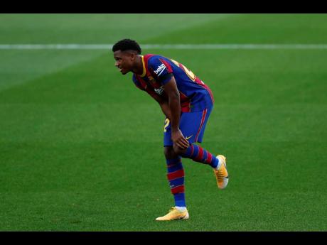 Barcelona’s Ansu Fati, gestures after he was fouled by Betis’ Aissa Mandi during the Spanish La Liga match between FC Barcelona and Betis at the Camp Nou stadium in Barcelona, Spain, Saturday, November 7, 2020. 