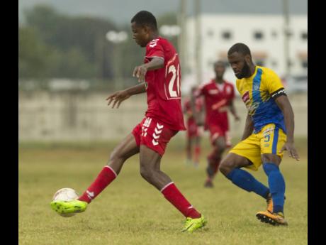 UWI FC’s Andre Bernal (left) controls the ball ahead of Harbour View’s  Nicholas Beckett in a Premier League match on January 9, 2019.