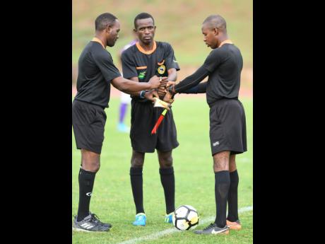 File Photos
Referees converge on the touchline at the Stadium East field before a Manning Cup match in 2018.