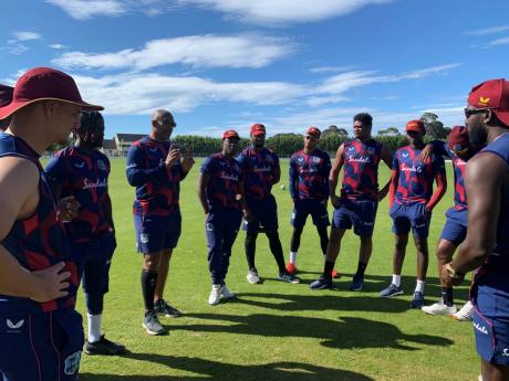 West Indies cricketers and coaching staff in a huddle during a recent training session  in News Zealand.