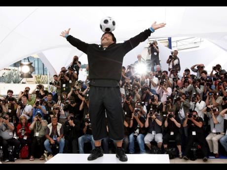 Credit: AP In this file photo from May 2008, Argentine football legend Diego Maradona poses during the photo call for the documentary “Maradona” during the 61st International film festival in Cannes, southern France.