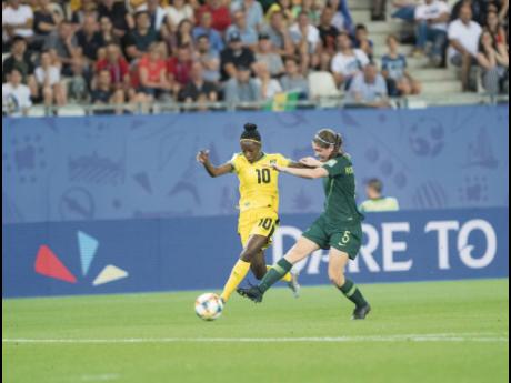 File
Jody Brown (left) moves past Australia’s Karly Roestbakken in the FIFA Women’s World Cup in 2019. 