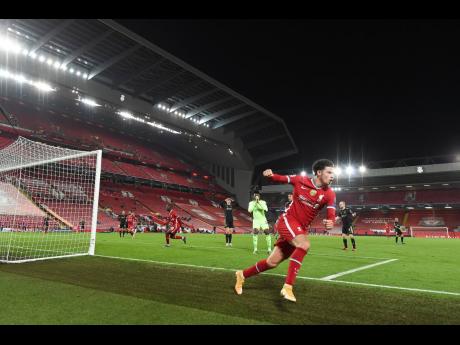 Credit: AP Liverpool’s Curtis Jones celebrates scoring his side’s first goal during the Champions League Group D match against Ajax at Anfield stadium in Liverpool, England, on Tuesday, December 1.