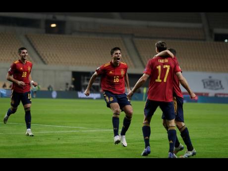 Credit: AP Spain's Ferran Tores, centre, runs to celebrate with teammates after scoring against Germany during the UEFA Nations League match between Spain and Germany in Seville, Spain, Tuesday, November 17, 2020.