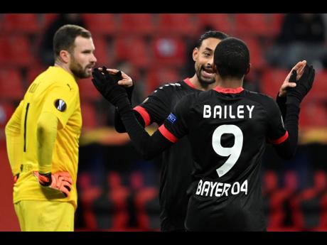 Leverkusen’s Karim Bellarabi (background) and Leverkusen’s Leon Bailey celebrate after Bailey scored his side’s second goal during the Europa League Group C match between Bayer Leverkusen 04 and Slavia Prague at the BayArena in Leverkusen, Germany, yesterday.