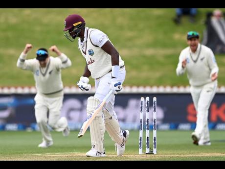 Credit: Andrew Cornaga West Indies’ captain Jason Holder, centre, is bowled by New Zealand’s Tim Southee during play on the fourth day of their second cricket test at Basin Reserve in Wellington, New Zealand, on December 14, 2020.