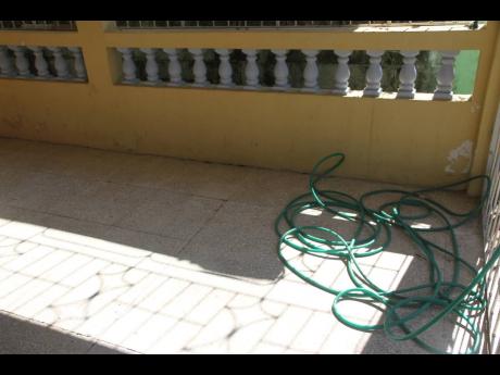 The hose used to wash away the blood of Janet Mundle-Reeves who was shot and killed on her verandah Wednesday night by unknown assailants.