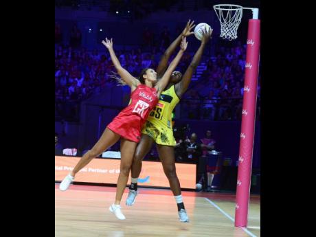 Credit: File Sunshine Girls captain Jhaniele Fowler (right) outstretches England Rose’s goal keeper, Geva Mentor, to claim the ball before scoring a goal during their Group G Vitality Netball World Cup match last year.