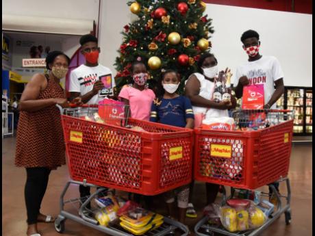The family (from left) Petrona Anderson, Jalil Bundy, Tussanne Smart, Brittania Bundy, Marsha Smart and Tussan Smart take a  break from shopping.