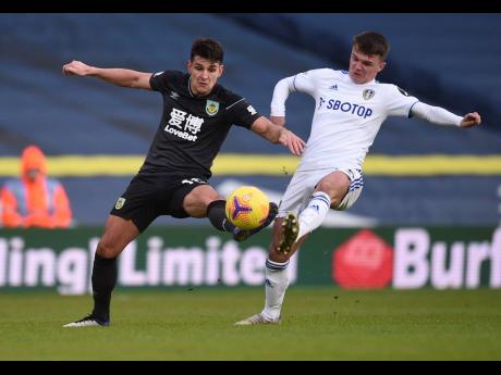 Burnley’s Ashley Westwood (left) duels for the ball with Leeds United’s Jamie Shackleton during their English Premier League match  at Elland Road Stadium in Leeds, England, yesterday.