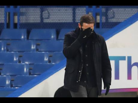 Chelsea’s head coach Frank Lampard covers his face during the English Premier League match between Chelsea and Aston Villa in London, England, yesterday.