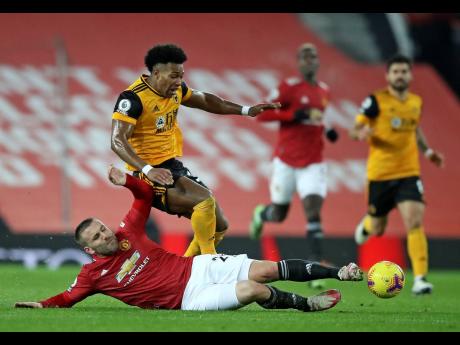 Manchester United’s Luke Shaw challenges Wolverhampton Wanderers’ Adama Traore during the English Premier League match between Manchester Utd and Wolverhampton Wanderers at Old Trafford stadium in Manchester, England, yesterday.