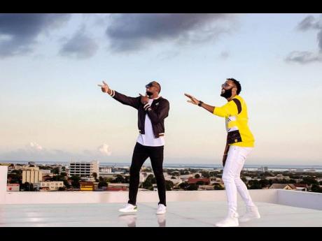 Usain Bolt (left) and NJ in a scene from the music video for ‘Living The Dream’.