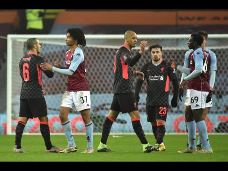 Players shake hands after the FA Cup third-round match between Aston Villa and Liverpool at Villa Park stadium in Birmingham, England, on Friday, January 8.