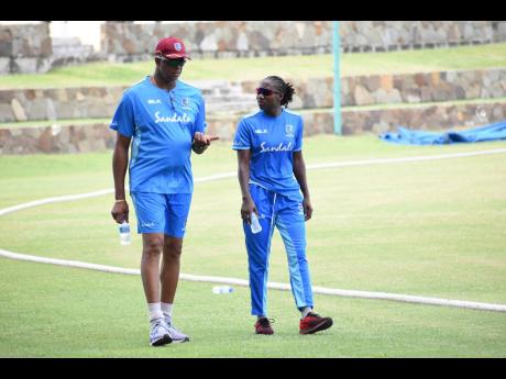 West Indies women’s head coach Courtney Walsh converse with Stafanie Taylor during a training session in last year.