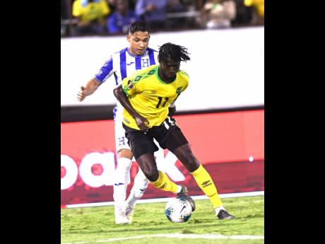 File
Jamaica’s Shamar Nicholson  dribbles ahead of Honduran player Emilio Izaguirre  in their Concacaf Gold Cup match held at the National Stadium in 2019.