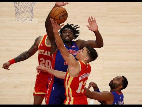 Credit: Contributed Bogdan Bogdanovic of the Atlanta Hawks tries to lay-up a shot against Detroit Pistons’ Isaiah Stewart in the second half of a NBA match at the State Farm Arena in Atlanta, Georgia, on December 28, 2020.