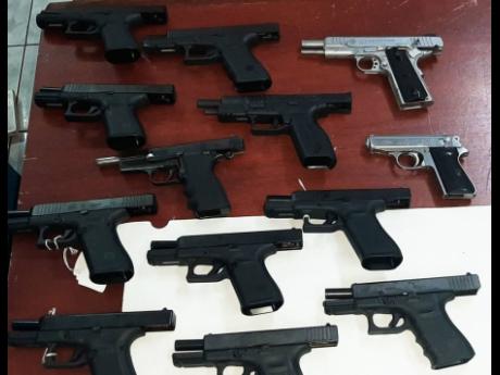 The 13 illegal handguns recovered during the operation at the Freeport wharf in Montego Bay.