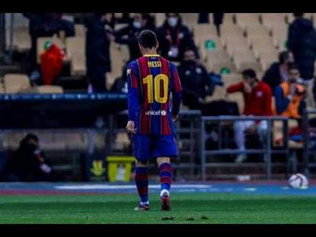 Barcelona’s Lionel Messi walks out of the pitch after being shown a red card during the Spanish Supercopa final match against FC Barcelona at La Cartuja stadium in Seville, Spain, on Sunday.