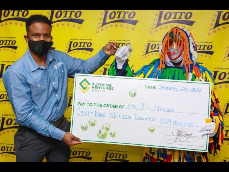 Stefan Miller (left) celebrates with the first Lotto winner for 2021, D. Nelson, who copped a jackpot of $69 million, did it with the lucky numbers 07, 09, 14, 17, 30 and 33 on January 6.
