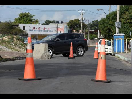 The entrance to Denham Town was blocked by the police on Monday, 24 hours after the shooting death of Harry ‘Harry Dog’ McLeod along Darling Street in the vicinity of Coronation Market in western Kingston.
