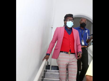 Beenie Man walks from the courtroom.