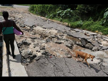 Credit: File A road in St Andrew which was damaged after heavy rains caused flooding last year.
