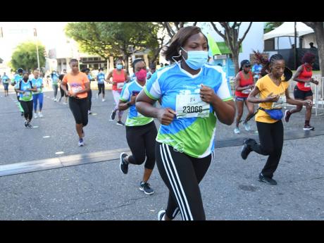 Participants take part in the Sagicor SIGMA Corporate 5K run yesterday in New Kingston.
