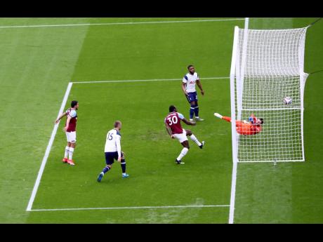West Ham’s Michail Antonio (third left) scores his side’s opening goal during the English Premier League soccer match between West Ham United and Tottenham at the London Stadium in London, Saturday, February 21, 2021.