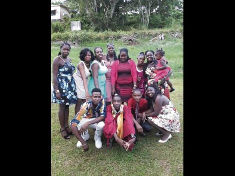 Thorn Francis (stooping, second left) with relatives at his graduation from Ferncourt High School.
