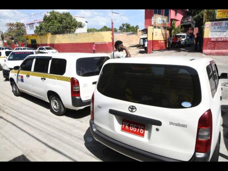 Taxi operators parked their vehicles to demonstrate the condition of a section of Waltham Park Road. But aided by the police, they attempted to rehabilitate the roadway and clear a nearby gully. 