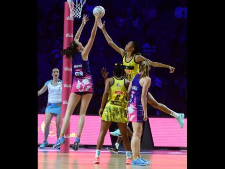 Jamaica goalkeeper Shamera Sterling (second right) goes high to defend ahead of Scotland goal shooter Emma Barrie (left), while Jamaica’s Adean Thomas (second left) and Lynsey Gallagher(GA) look on during their Vitaly Netball World Cup Group G game at the M&S Bank Arena in Liverpool, England, on July 17, 2019.