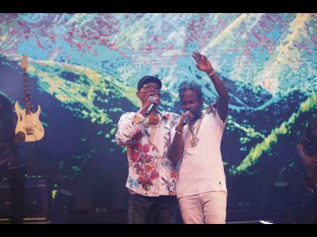Surprise guest for the show, Popcaan (right) gets caught up in his performance with Beres.