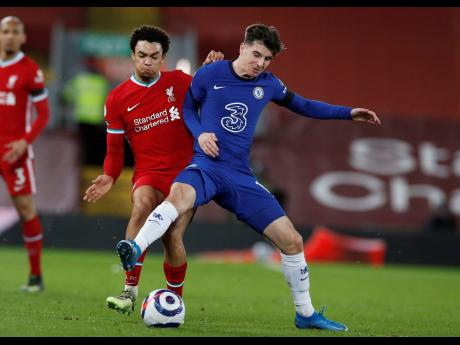 Chelsea’s Mason Mount (right)  challenges for the ball with Liverpool’s Trent Alexander-Arnold during the English Premier League match between Liverpool and Chelsea at Anfield stadium in Liverpool, England, yesterday.