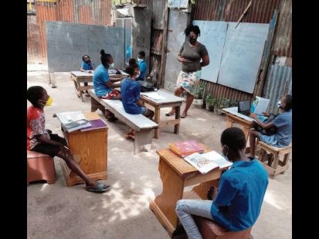 Powell goes over lessons with her students. 