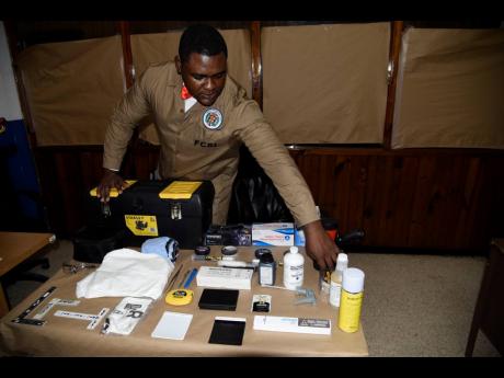 Credit: Nicholas Nunes/Photographer Campbell shows off some of the tools he uses.