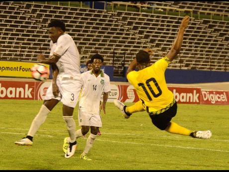 FILE
Romario Williams (right) kicks the ball on the volley pass Joel Baja(left) and Sergio Eduard (centre) from Suriname during the Caribbean Cup qualifier at the National Stadium in 2016.