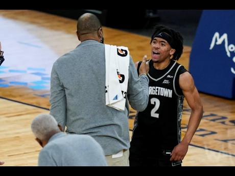 Georgetown’s Dante Harris (2) celebrates with coach Patrick Ewing after the team’s NCAA college basketball game against Seton Hall in the semifinals in the Big East men’s tournament Friday, March 12, 2021, in New York. 