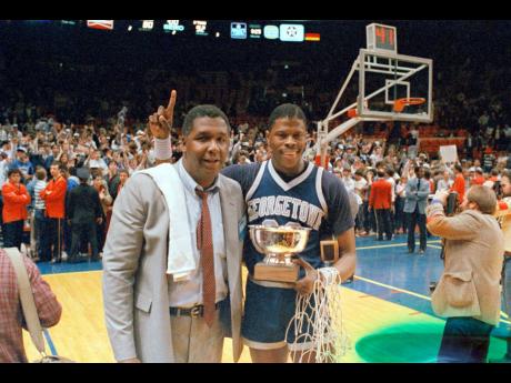  In this March 9, 1985, file photo, Georgetown NCAA college basketball head coach John Thompson poses with player Patrick Ewing after Georgetown defeated St John’s in the Big East Championship in New York.  