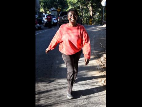 Ann Marie Kelly makes her way up the very steep Savage Pen Road in East Rural St Andrew.