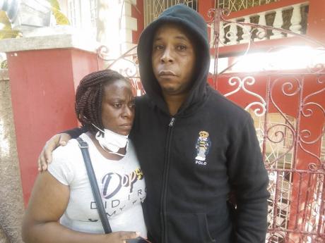 Satchell Brown (left) and her common-law husband Gregory Lambert mourn the loss of their son Omar.