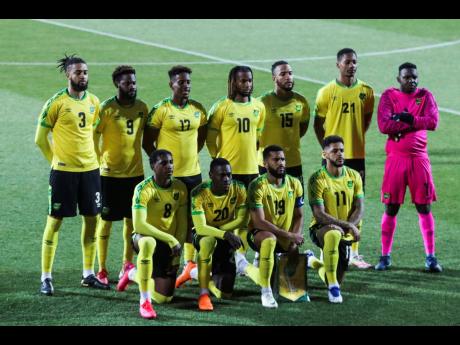 Jamaica players stand during the national anthem prior the international friendly soccer match between USA and Jamaica at SC Wiener Neustadt stadium in Wiener Neustadt, Austria, Thursday, March 25, 2021. 