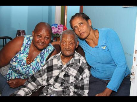 In this photo that was taken in January, Stephen Wright shares a light moment with niece Marcia Carnegie-Ramsamugh (left) and his and granddaughter Waldene Levy.