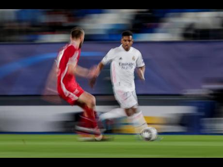 Real Madrid’s Rodrygo Silva (right) runs with the ball during the Champions League quarter-final first-leg match between Real Madrid and Liverpool at the Alfredo di Stefano stadium in Madrid, Spain, yesterday.
