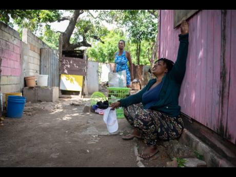 Denise Burrell speaks about the death of her cousin, Millicent Robinson, whose body was found in a shallow grave in her yard in Craig Town, St Andrew, on Sunday. 