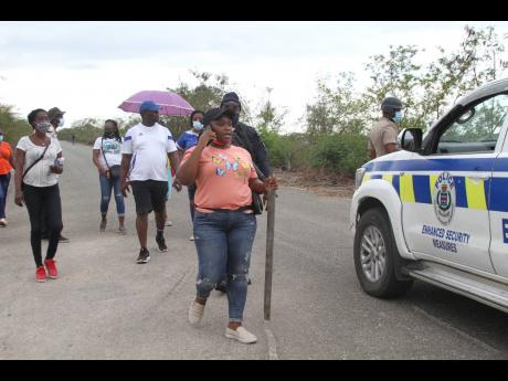 Sheida Smith, a teacher at Vere Technical High School in Clarendon, as she searched for her missing colleague, Nattalie Dawkins, in Sandy Bay on Wednesday.