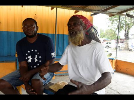 Samson ‘Jeffrey’ Bryan (left) and drummer Artnell ‘Sengeh’ Bernard talk about the longing for Kumina events in their St Thomas community.